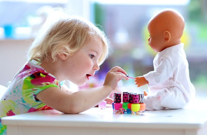 toddlers playing with dolls